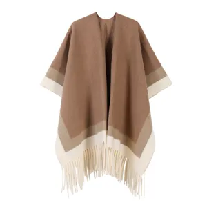 Detailed view of the ethnic style color-blocked knit poncho shawl featuring a stylish fringe hem.