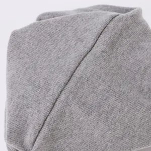 Detail en tissu de cache-cou en tricot côtelé gris montrant une texture douce et chaude.