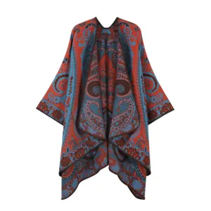 Detailed close-up view of the red and blue paisley knit poncho, showing vintage pattern.