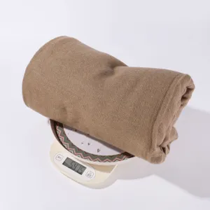 Detailed view of solid color imitation cashmere shawl blanket, showing fabric texture and weight.