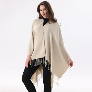 Details of women solid color tassel split knitted cape shawl, elegant winter fashion style.