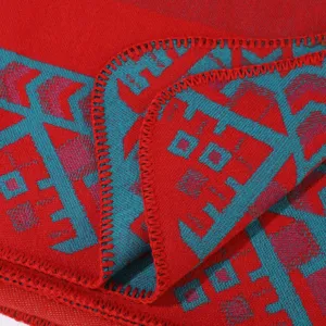 Primo piano sui dettagli del tessuto della coperta con motivo geometrico rosso