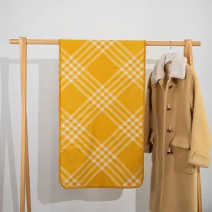 Yellow plaid winter scarf detail, cozy wool shawl, warm fringed edge blanket wrap.