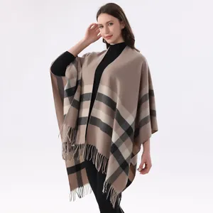 Detailed view of the women's classic plaid tassel poncho, showing soft fabric and details.