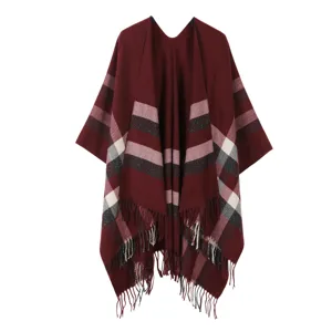 Women's stylish burgundy knitted fringe poncho cloak with classic striped pattern design.