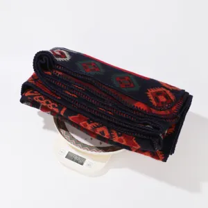 Geometric patterned cashmere-feel blanket shawl detail, soft warm winter wrap cape.