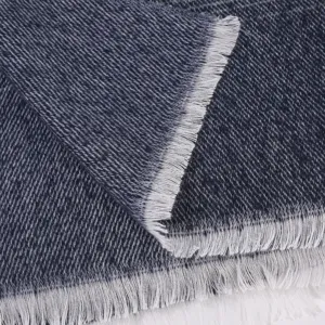 Close-up detail of women's stylish striped shawl fabric showcasing fine texture and white fringe.