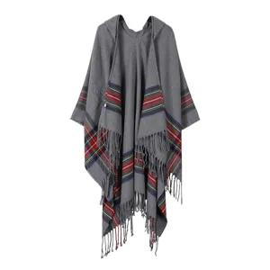 Detail view of grey hooded poncho with colorful plaid stripes and stylish tassel hem design.