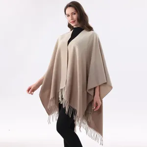 Gradient knitted shawl featuring elegant fringe trim, perfect for cozy styling and layering.