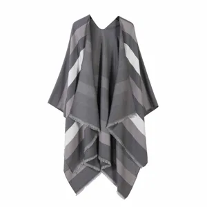 Detailed view of the women's grey striped poncho shawl with stylish fringe hem design.