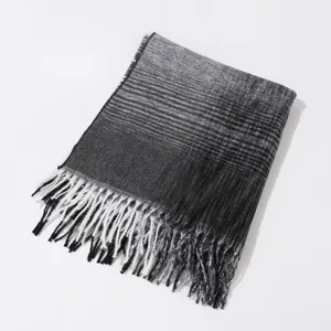 Detailed shot of the black and white gradient warm scarf with classic stylish fringe details.