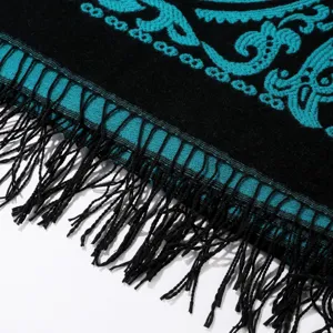Nahaufnahme Detail des eleganten schwarzen und türkisen Paisleymuster Schals mit Fransen.