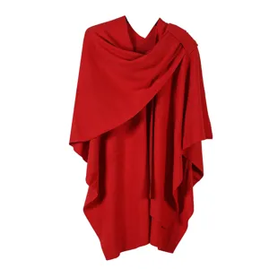 Red knit cape fabric texture close-up, soft yarn and elegant drape detail view.