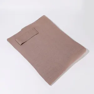 Detailed view of the knitted solid color cape shawl with strap feature, soft texture.