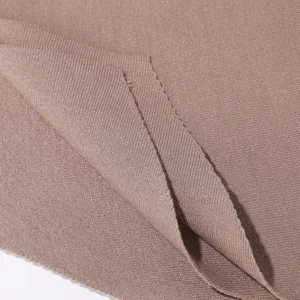Close-up detail of knitted core-spun yarn fabric showcasing fine texture and soft feel.