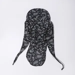 Close-up detail of the breathable black and white paisley long tail cycling cap fabric.