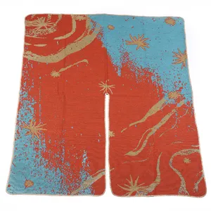 Detailed view of the knitted cape shawl, showing soft texture and abstract starry pattern.