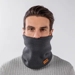 Dettaglio dello scaldacollo in maglia grigio scuro foderato in pile indossato, accessorio invernale.