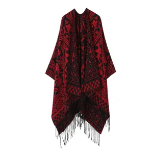 Ethenischer Strick-Fransen-Schal Umhang Detail mit rot schwarzem Muster und Textur.