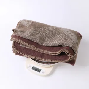 Detailed view of the ethnic style vintage horse pattern warm shawl cape, cozy knit blanket texture.