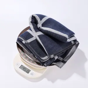 Detailed view of the cozy plaid shawl fabric placed on a digital scale for weight display.