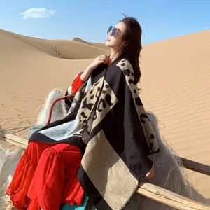 Leopard print geometric color-block shawl cape detail showing fine knit texture design.