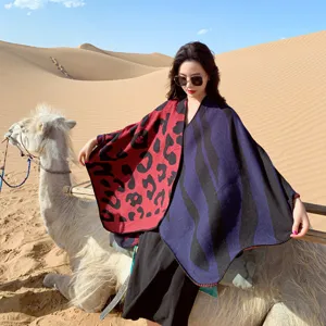 Stylish color-block knit shawl with leopard and zebra patterns for chilly days outdoor view.