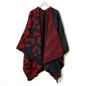 Reversible leopard print knitted poncho shawl, cozy winter warmth cape detail view.