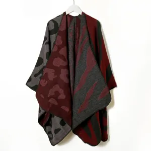 Detail view of the winter colorblock knit cape featuring striking leopard and zebra patterns.