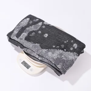 Detailed view of the knitted jacquard horse pattern cape weight display on digital scale