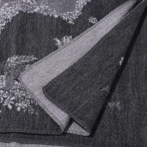 Vintage horse pattern knitted shawl detail view, cozy winter fashion jacquard cape fabric.