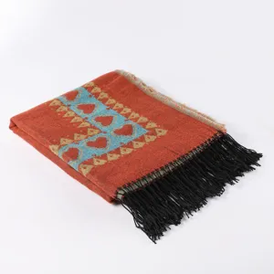 Detailed view of the ethnic style woven scarf with geometric heart pattern and black fringe.
