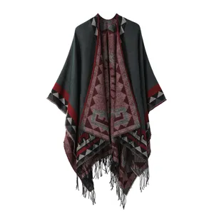 Bohemian ethnic style knitted cape shawl with geometric tribal patterns and fringe hem.