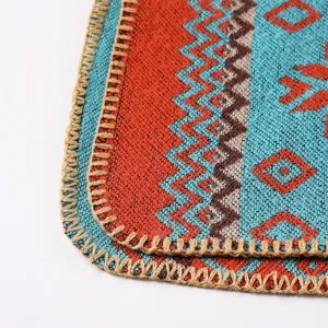 Close-up detail view of ethnic style knitted wool shawl, geometric pattern, cozy blanket edge.