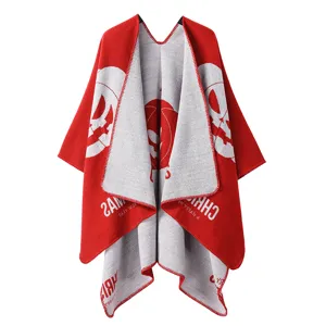 Knitted double-sided autumn winter red poncho cape with festive pumpkin design details.