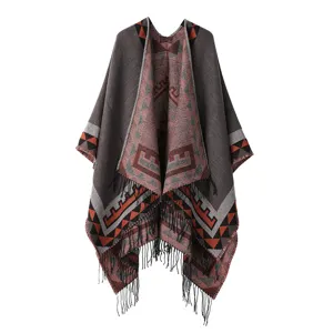 Detailed view of the bohemian ethnic geometric tassel poncho, exquisite knit texture and fringe design.