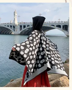 Thickened hooded cape shawl with stylish black white floral print design for women outdoor travel.