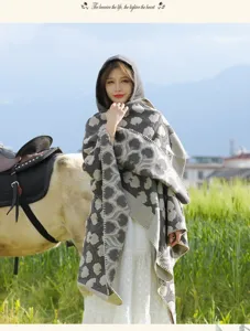 Outdoor travel hooded shawl detail in grassland, ethnic pattern warm thickened cloak for women.