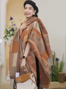 Detailed view of women's autumn winter plaid tassel shawl cape with cozy knit design.