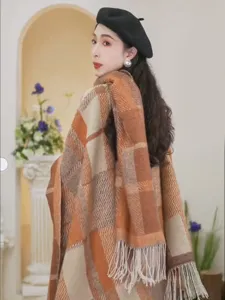 Cozy autumn plaid tassel shawl for women, chic knitted cape scarf with warm retro style.