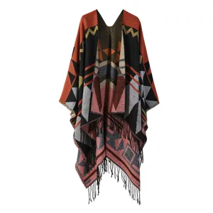 Geometric pattern knit shawl detail, ethnic style cape with fringe tassel trim, cozy winter wear.