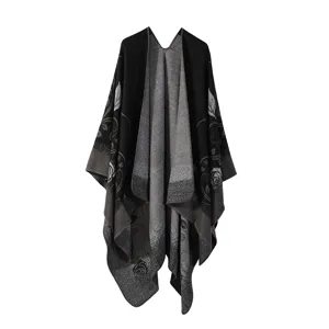 Detailed view of women's retro knitted floral shawl cape, warm winter black cloak.
