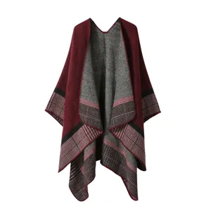 Detailed view of women winter plaid imitation cashmere shawl cloak hem texture close up