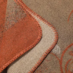 Detailed shot of a vintage ethnic style knitted shawl, featuring warm fabric and thick whipstitch.