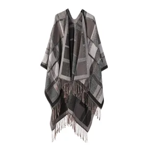 Detailed view of the stylish grey plaid knitted cape with fringe tassels for women.
