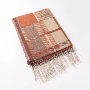 Autumn winter plaid fringed shawl scarf, cozy knit design in warm orange and brown tones.
