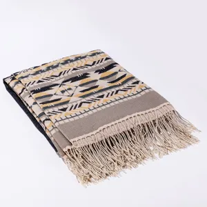 Ethnic style geometric patterned winter warm shawl and scarf with fringe detail shot.