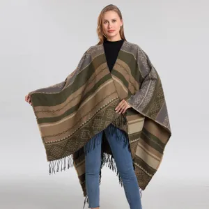 Λεπτομέρεια από boho πλεκτό πόντσο με γεωμετρικό ριγέ σχέδιο και τελείωμα με κρόσσια.