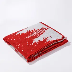 Detailed view of the red and white knitted Christmas tree patterned shawl or scarf.