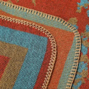 Close-up of autumn winter geometric striped cashmere-feel shawl blanket edge detail.